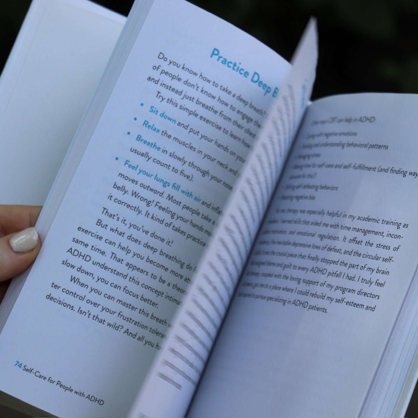 A woman holding the Self-Care for People with ADHD Hardcover Book open to show off its pages.