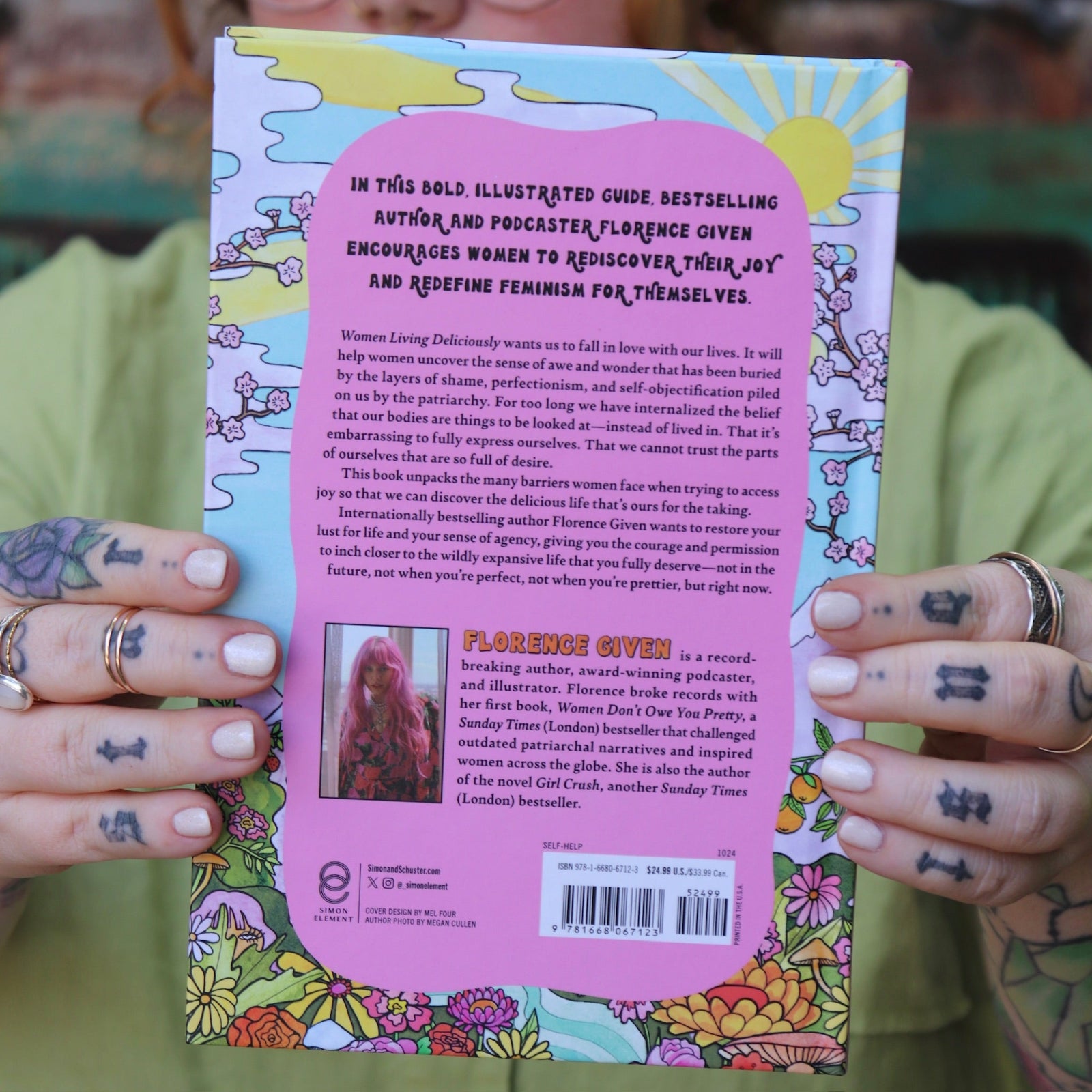 A woman holding the Women Living Deliciously Hardcover Book.