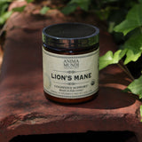 The Lion's Mane - 5oz Brain Super-Tonic Powder on a rusty red surface next to ivy.