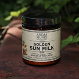 The Golden Sun Milk - 5oz Energizing Adaptogenic Chai Powder on a red surface next to ivy.