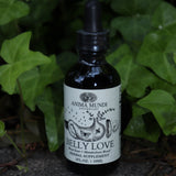 The Belly Love - 2oz Metabolism + Digestive Support Tonic in front of ivy.