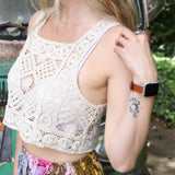 A woman wearing the beige Handmade Vintage Crochet Design Camisole with tie-dye bottoms.