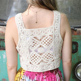 A woman wearing the beige Handmade Vintage Crochet Design Camisole with tie-dye bottoms.