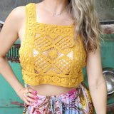 A woman wearing the yellow Handmade Vintage Crochet Design Camisole with tie-dye bottoms.