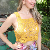 A woman wearing the yellow Handmade Vintage Crochet Design Camisole with tie-dye bottoms.