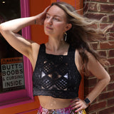 A woman wearing the black Handmade Vintage Crochet Design Camisole with tie-dye bottoms.