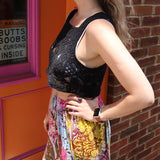A woman wearing the black Handmade Vintage Crochet Design Camisole with tie-dye bottoms.
