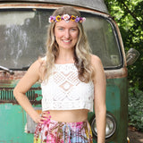 A woman wearing the white Handmade Vintage Crochet Design Camisole with tie-dye bottoms.