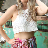 A woman wearing the white Handmade Vintage Crochet Design Camisole with tie-dye bottoms.