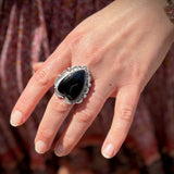 Someone wearing the Black Onyx Crystal Heart Adjustable Sterling Silver Ring.