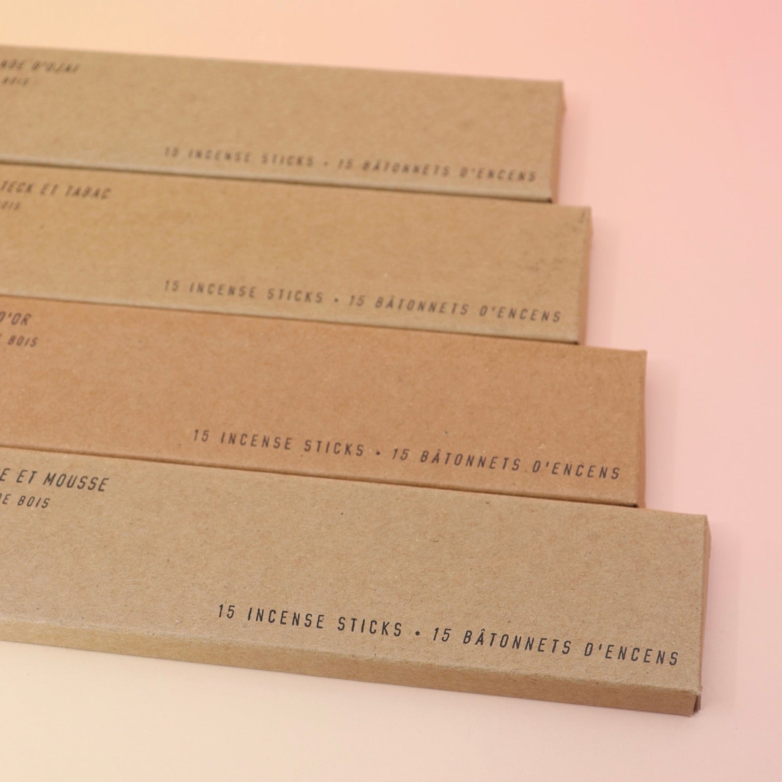All four P.F. Candle Co. incense (Amber & Moss, golden Coast, Teakwood & Tobacco, and Ojai Lavender) on a pink and yellow background.
