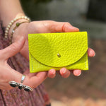 Someone holding the Chartreuse Leather Cardholder.