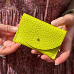 Someone holding the Chartreuse Leather Cardholder.