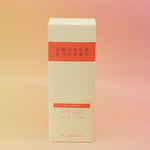 The Smoked Cherry – HI-FI Reed Diffuser box on a pink and yellow background.