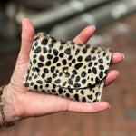 Someone holding the Tiny Spotted Hair on Hide Cardholder.