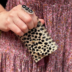 Someone holding the Tiny Spotted Hair on Hide Cardholder.