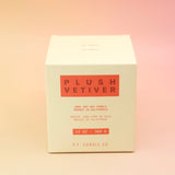 The Plush Vetiver - HI-FI Soy Wax Candle box on a pink and yellow background.