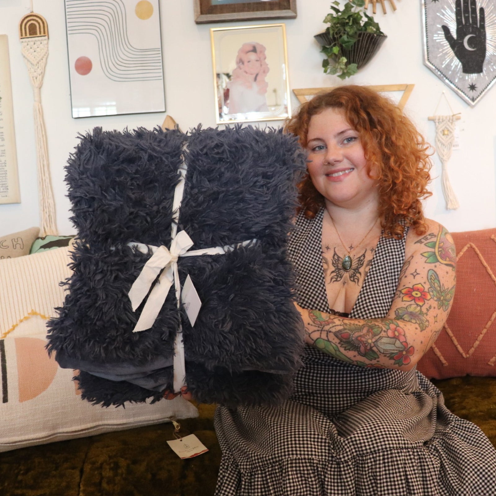 A woman holding the Blue Grisaille Dreamy Faux Fur Throw Blanket.