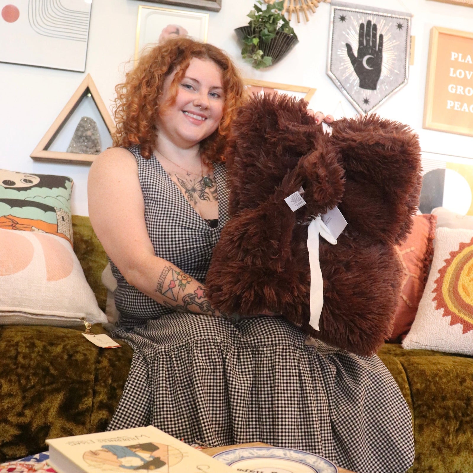 A woman holding the Brown Fudge Dreamy Faux Fur Throw Blanket.