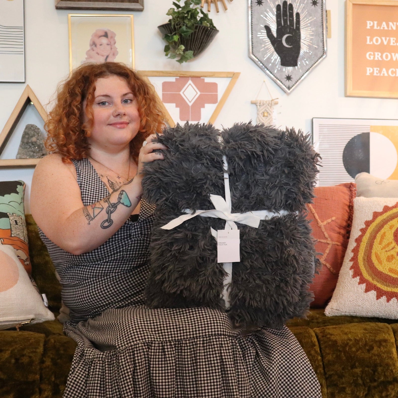 A woman holding the Pearl Grey Dreamy Faux Fur Throw Blanket.
