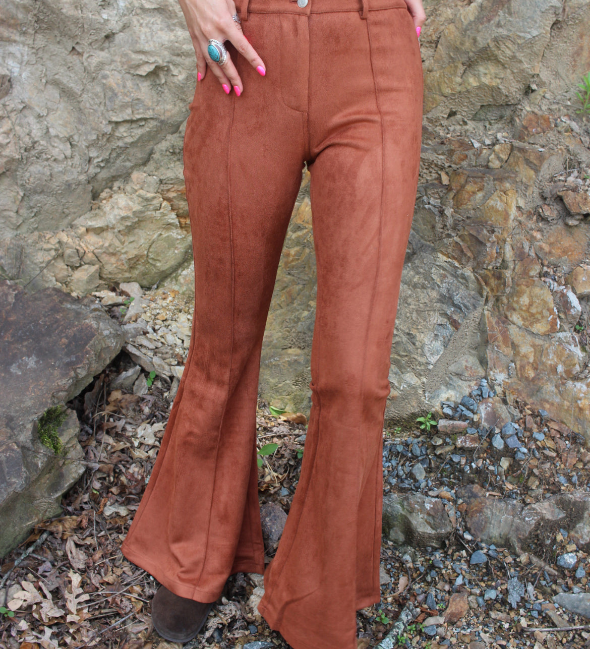 Someone wearing the Pecan Suede Bell Bottoms with an orange, red, and brown top.