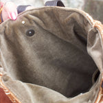 Someone holding the Geometric Rust Mud Cloth Tote with Pink Faux Fur open to show the inside.