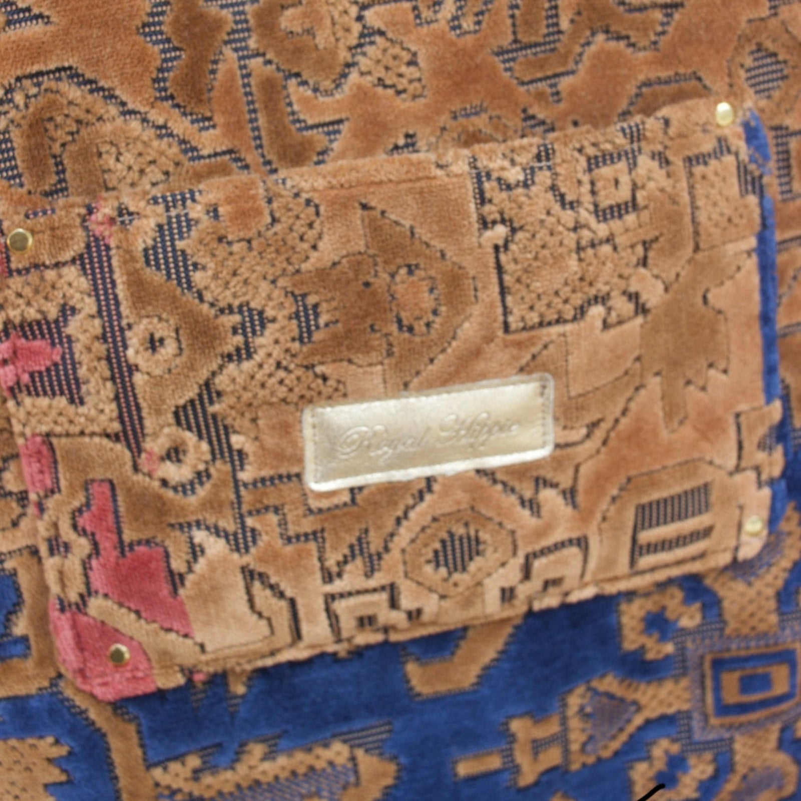An up close image of the Geometric Velvet Tapestry Tote with Pink Faux Fur.