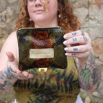 Someone holding the Snake Print Mini Coin Card Pouch.