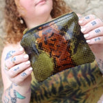 Someone holding the Snake Print Mini Coin Card Pouch.
