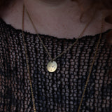 Someone wearing the Cancer 14k Gold Dipped Nickel-Free Zodiac Necklace with a black net top.
