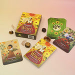 The Lammas Oracle Card Deck and its contents surrounded by tumbled crystals on a pink and yellow background.