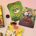 The Lammas Oracle Cards on a pink and yellow background.