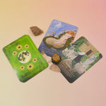 The Lammas Oracle Cards on a pink and yellow background.