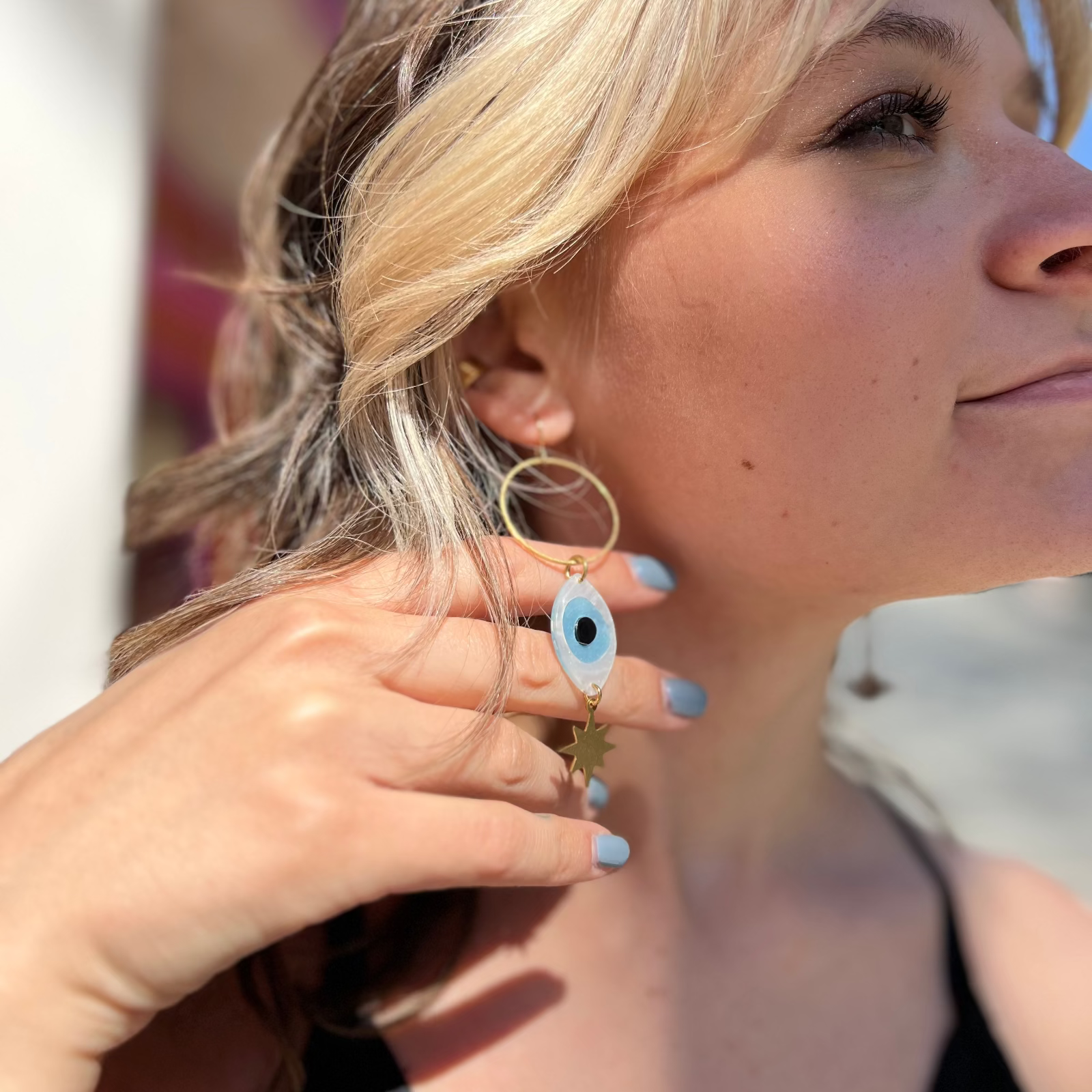A woman wearing the Brass Future Vision 3 inch. Earrings.