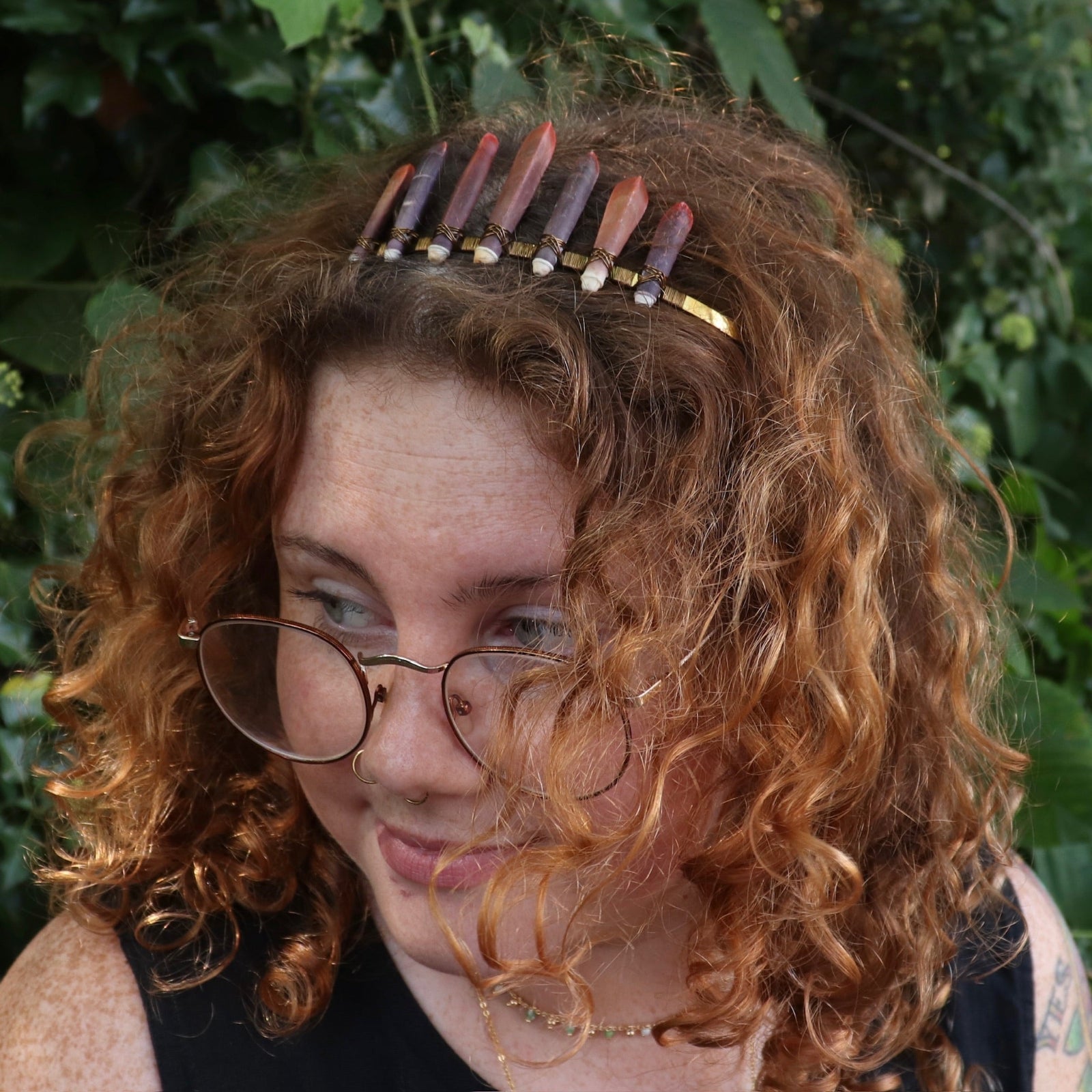A woman wearing the Fairy Crown / Celtic Tiara - Sea Urchin Spines II in front of greenery.