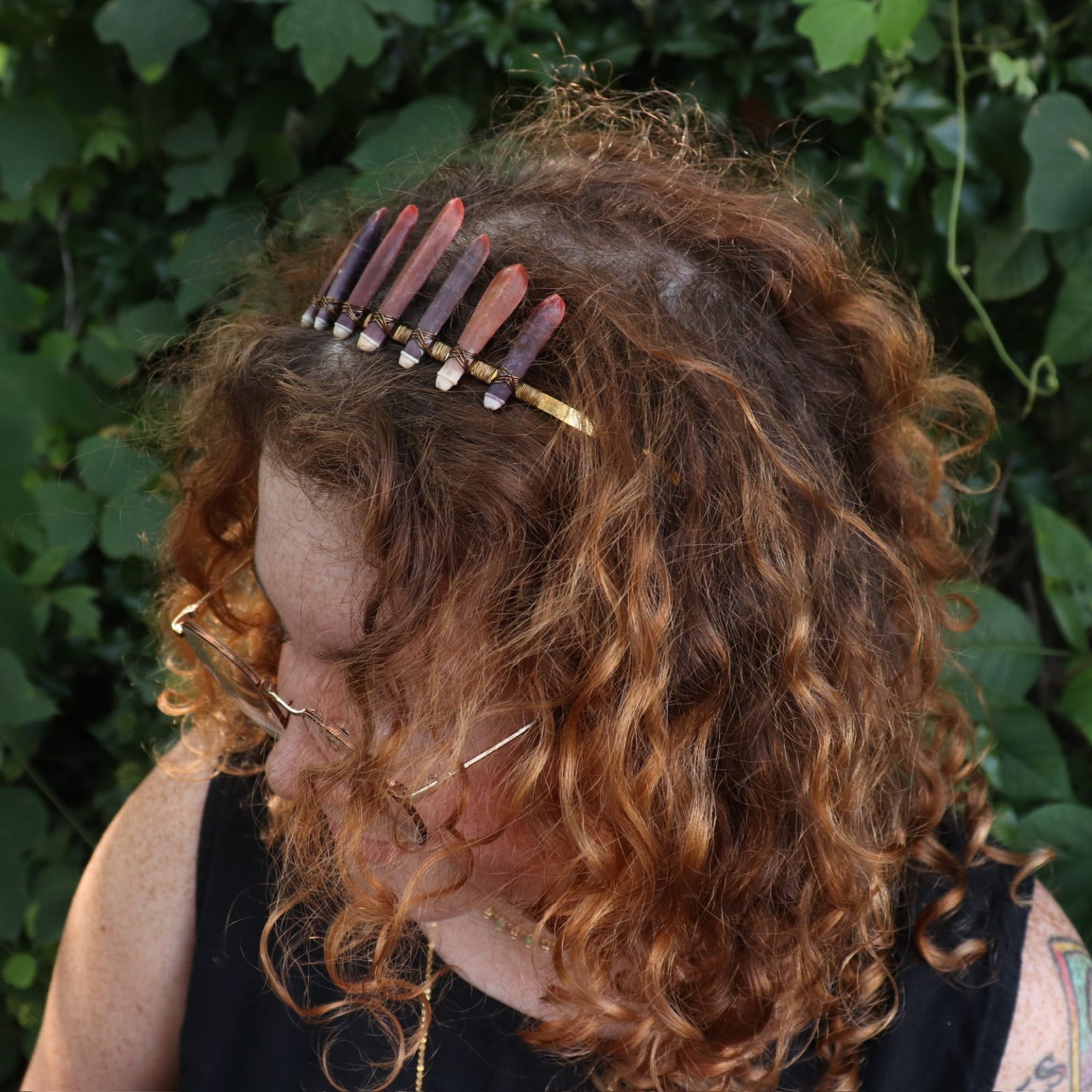 A woman wearing the Fairy Crown / Celtic Tiara - Sea Urchin Spines II in front of greenery.