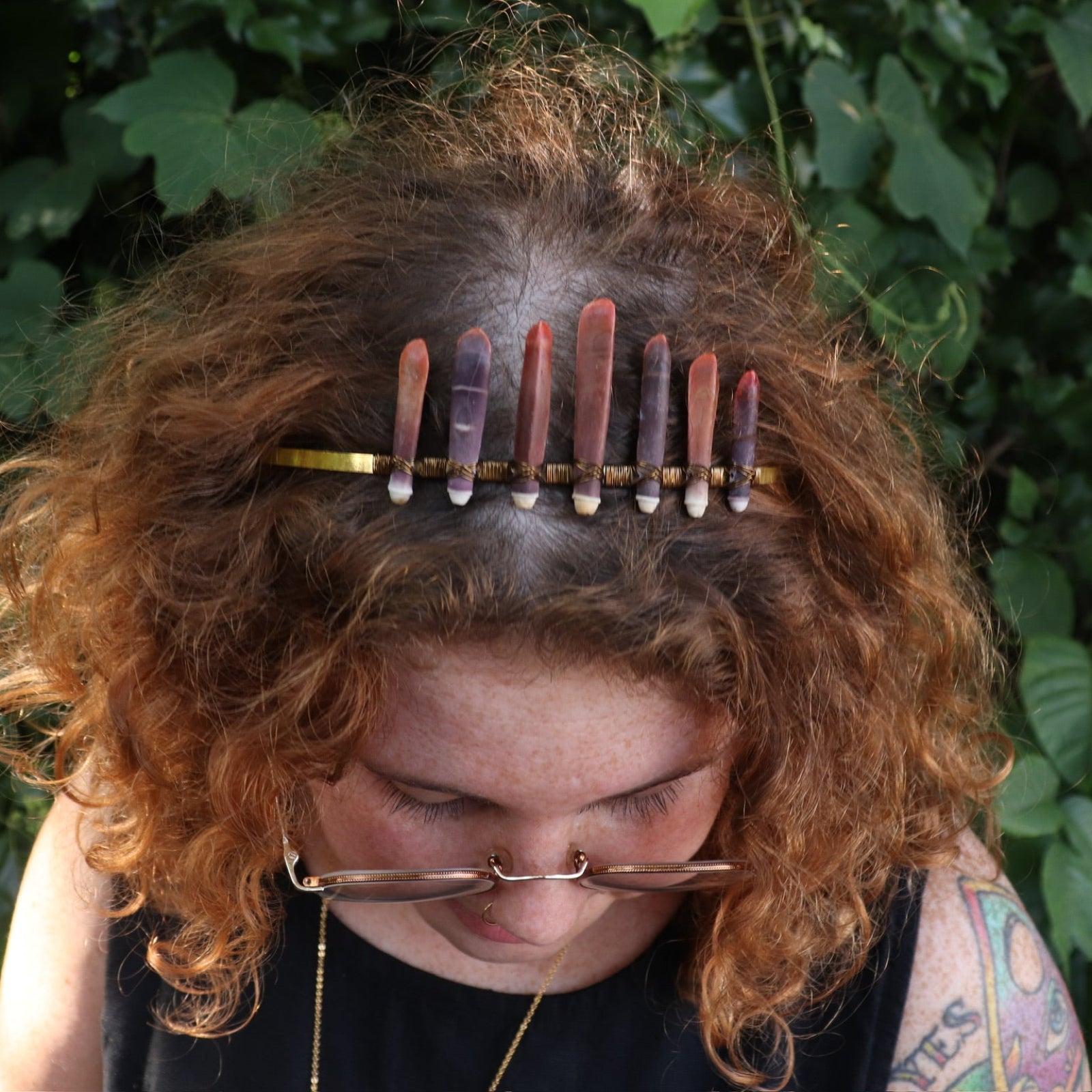 A woman wearing the Fairy Crown / Celtic Tiara - Sea Urchin Spines II in front of greenery.