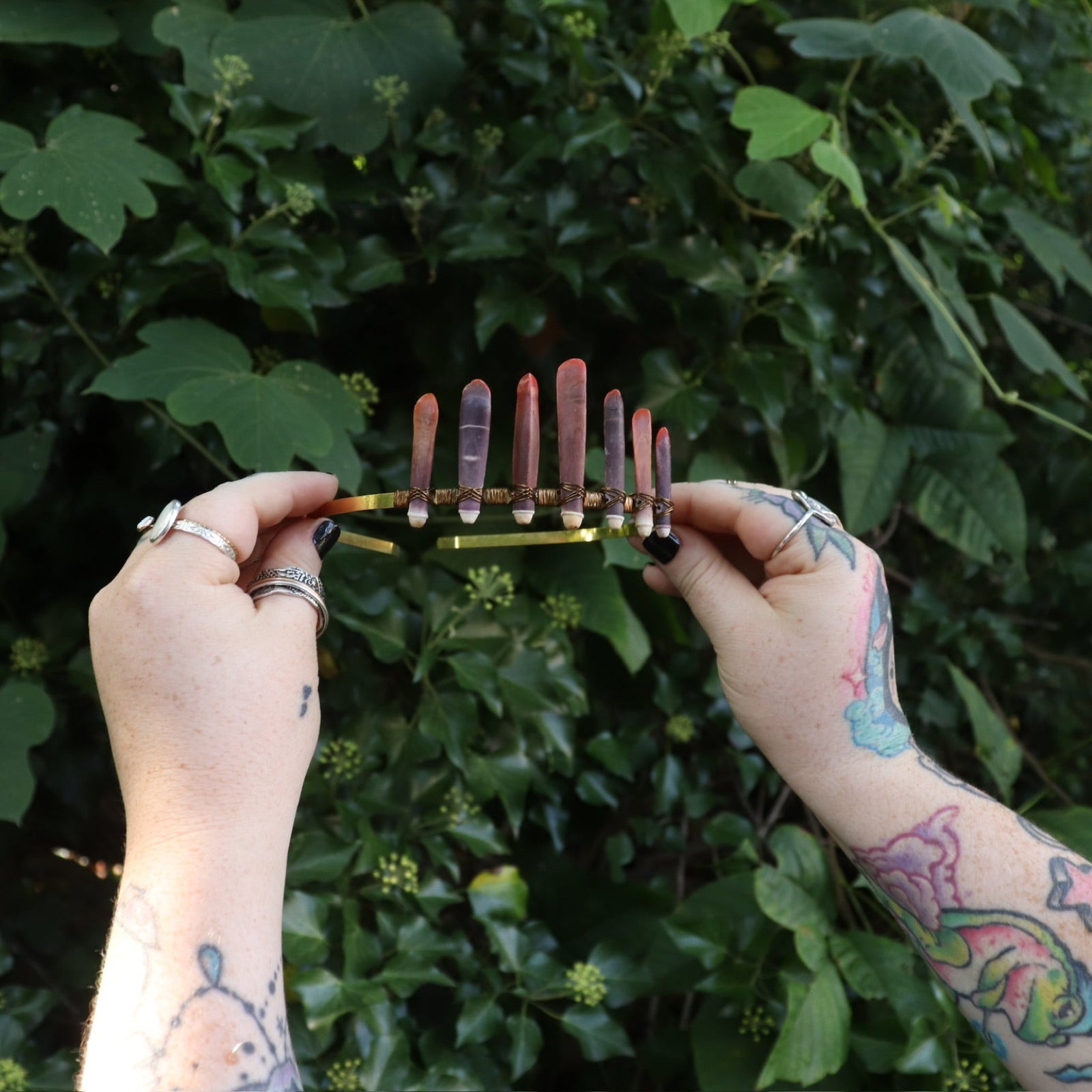 Someone holding the Fairy Crown / Celtic Tiara - Sea Urchin Spines II in front of greenery.