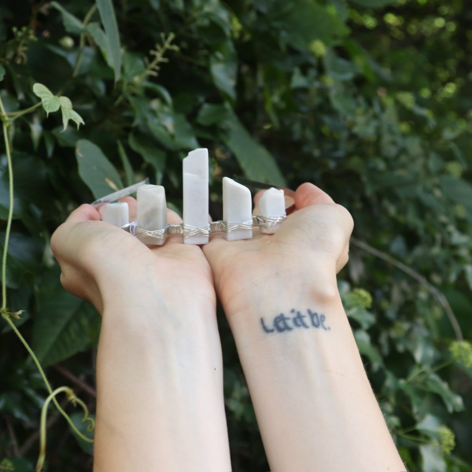 Someone holding the Fairy Crown / Celtic Tiara - Moonstone - Ice Queen in front of greenery.