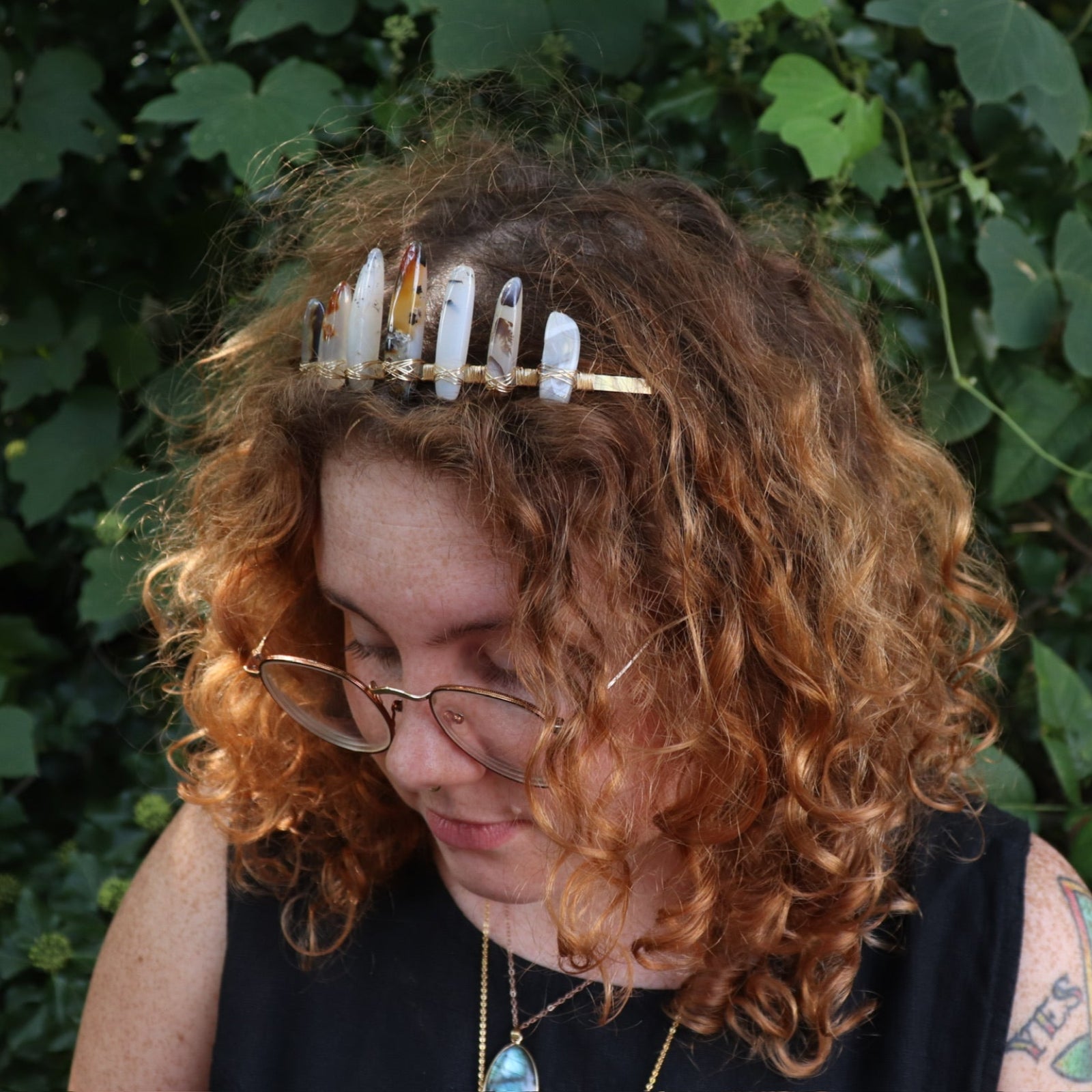 A woman wearing the Fairy Crown / Celtic Tiara - Agate Spears in front of greenery.