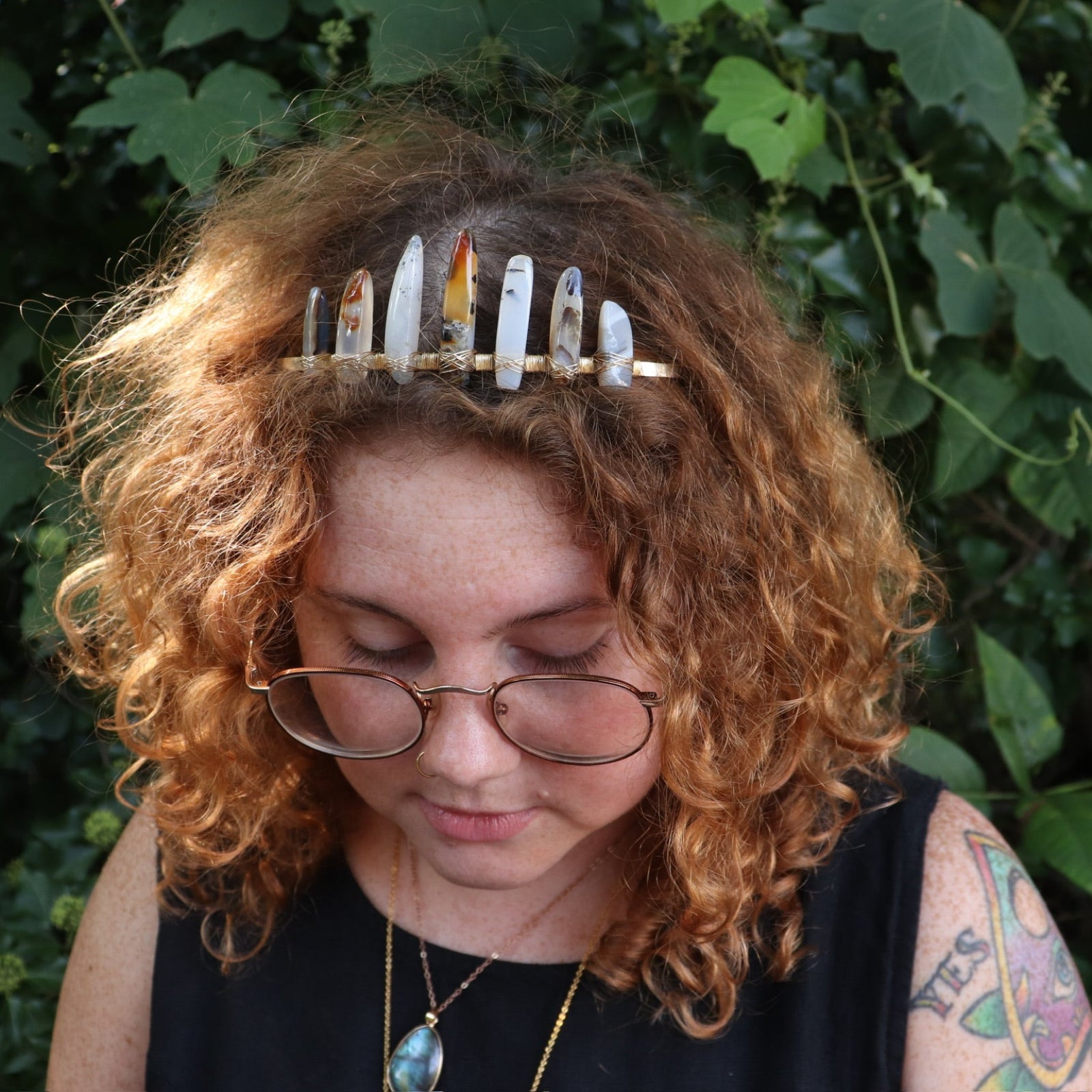 A woman wearing the Fairy Crown / Celtic Tiara - Agate Spears in front of greenery.