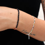 Someone wearing the Dainty Faceted Black Tourmaline beads + Copper Bracelet.
