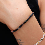 Someone wearing the Dainty Faceted Black Tourmaline beads + Copper Bracelet.
