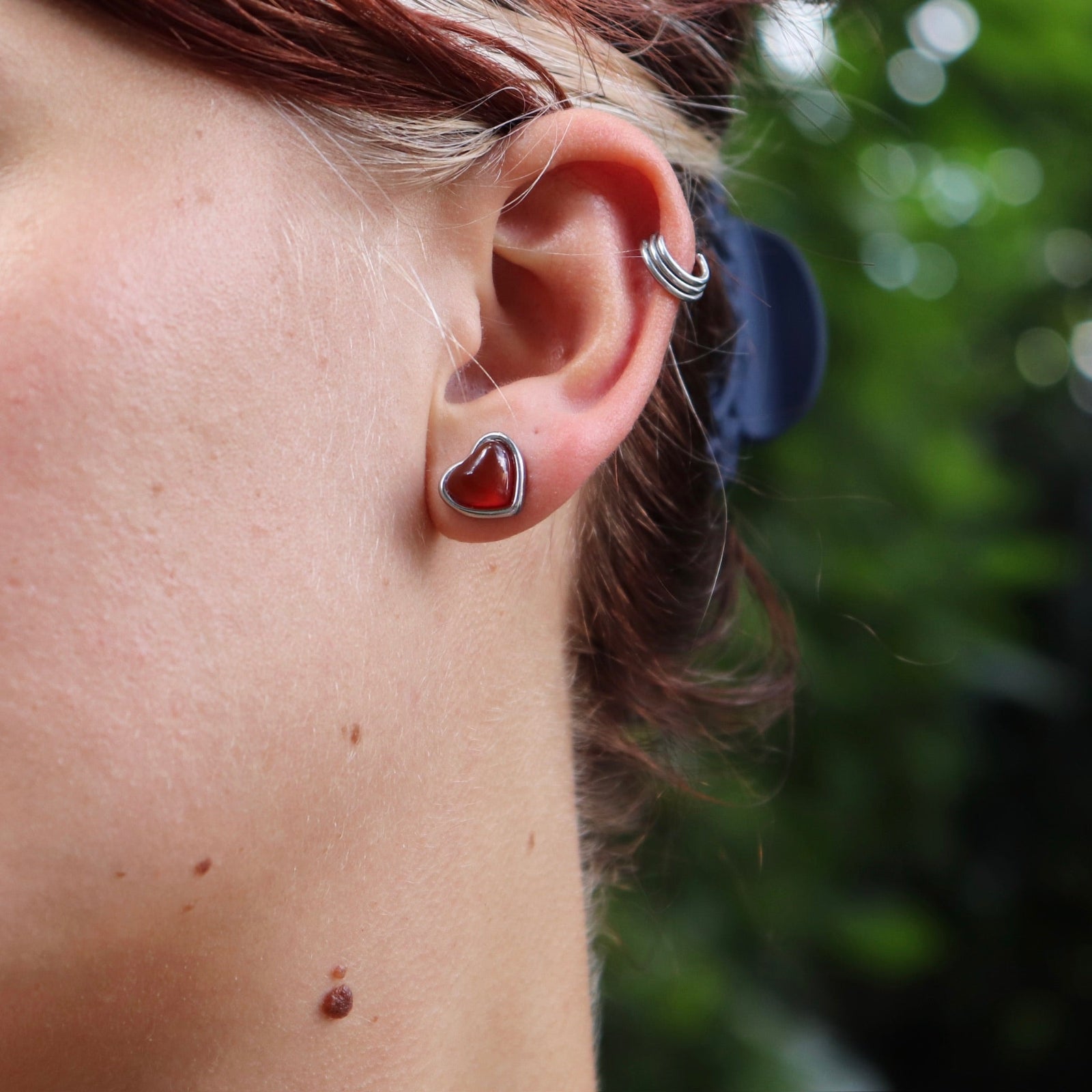 A woman wearing the silver earrings from the Carnelian Earrings & Necklace Gift Jewelry Set.
