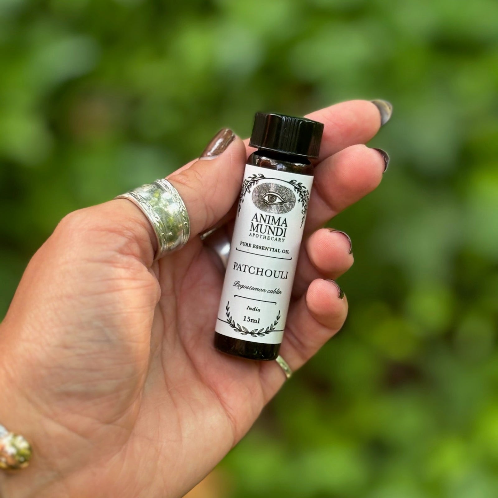 Someone holding the Patchouli Pure Essential Oil.