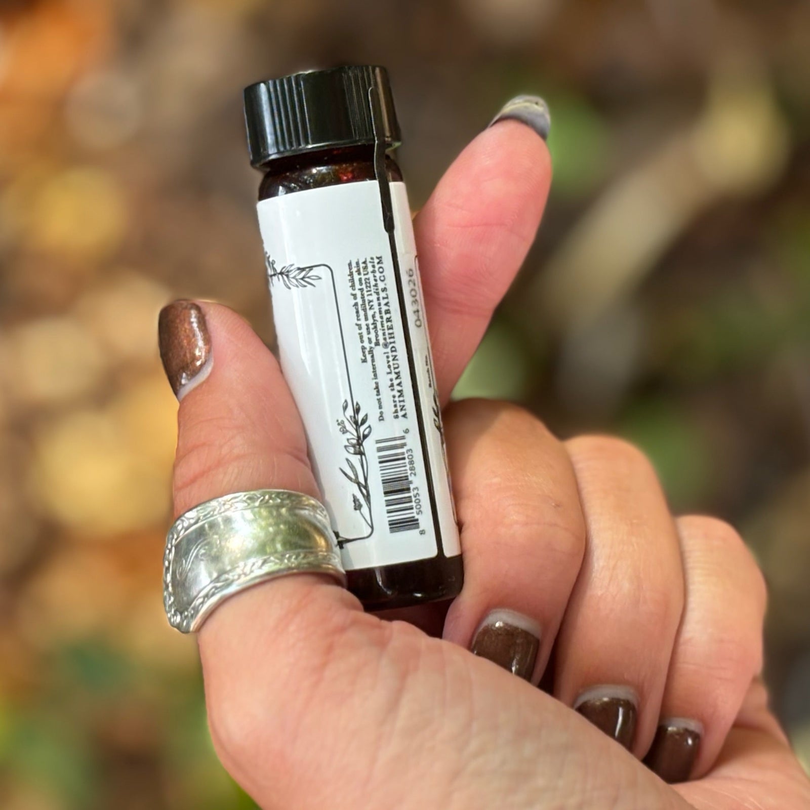 Someone holding the Patchouli Pure Essential Oil.