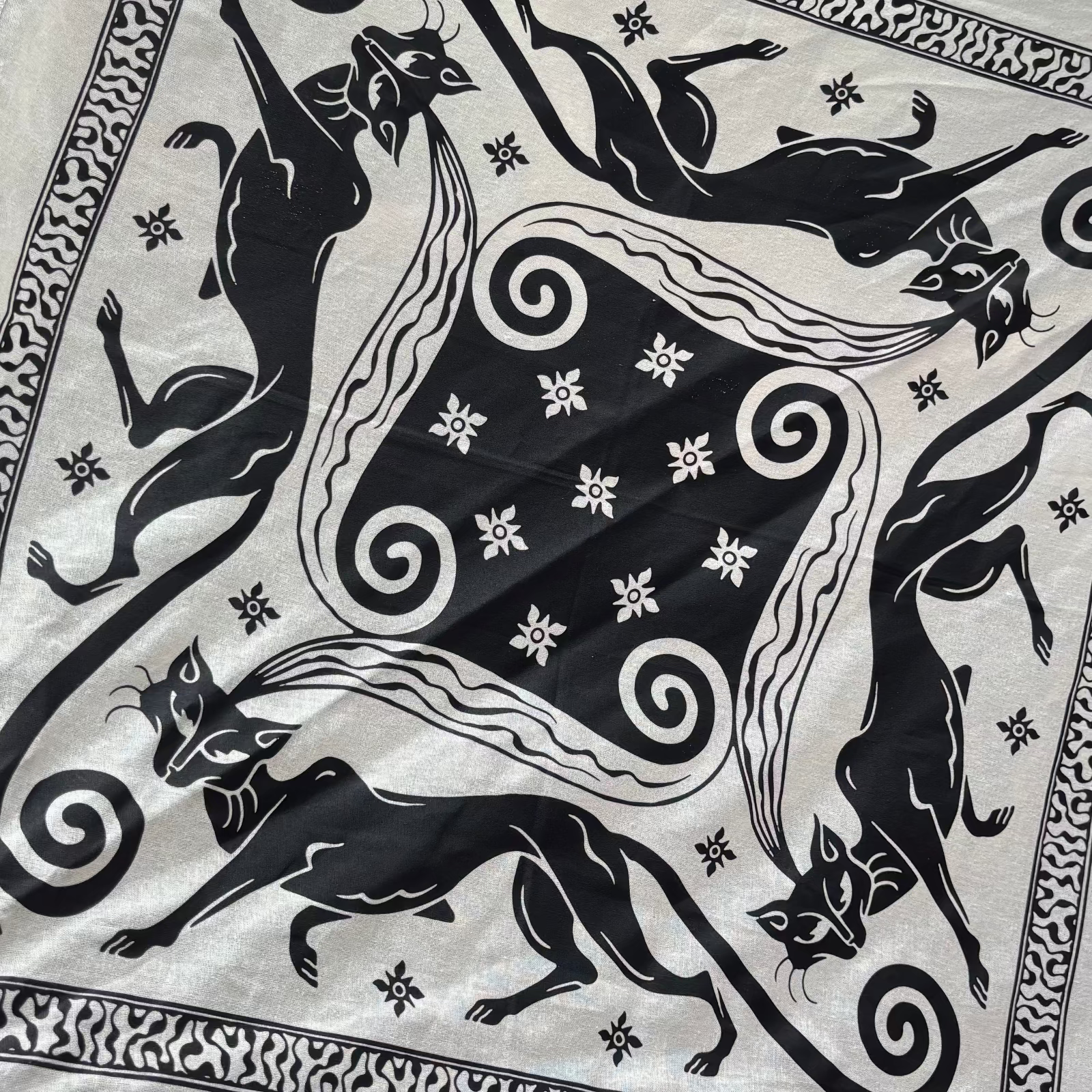 An up close image of the Screenprinted Chat Noir Cotton Bandana.