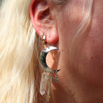 A woman wearing the Silver Sisters of the Moon 3 inch. Earrings.