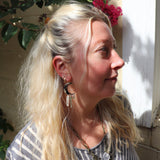 A woman wearing the Silver Sisters of the Moon 3 inch. Earrings.