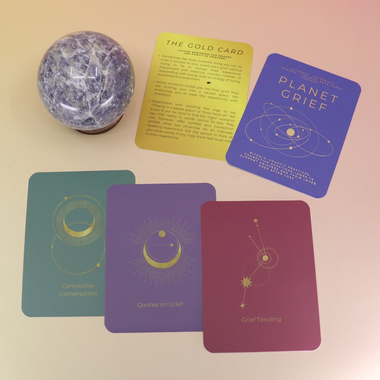 The contents of the Planet Grief Card Deck Bereavement Resource on a pink and yellow background.